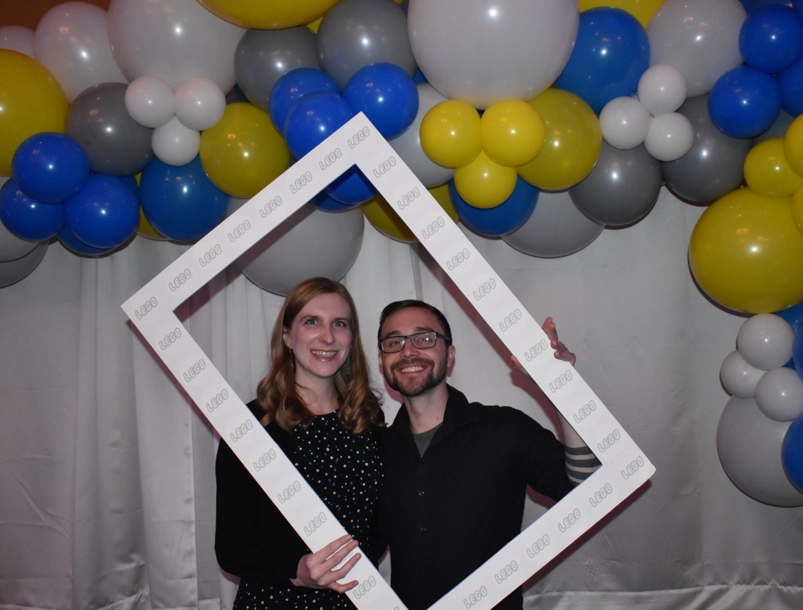 Two people holding picture frame